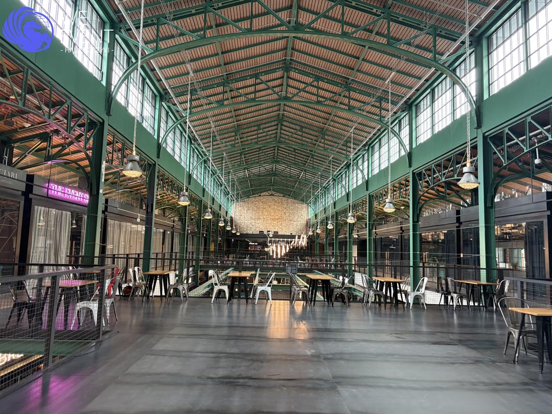 View over the interior of Hala Koszyki from the rooms' level — the historic 1909 structure